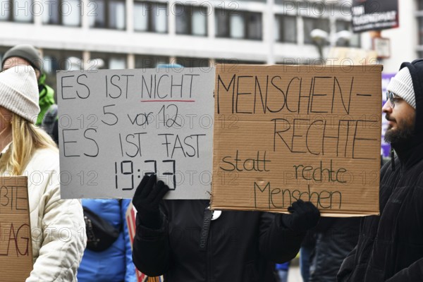 Heidelberg, Germany - February 12th 2025: People with signs with text at protest against far-right