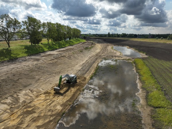 Oberhausen, North Rhine-Westphalia, Germany, renaturalisation of the Emscher in the Holtener Bruch. A new floodplain landscape for flood protection and biodiversity is being created here. The Emscher, which is currently straightened, is being given curves again and can meander through its new floodplain. The ecological reorganisation of the Emscher system consists of the construction of a central wastewater treatment system in the Ruhr area, the construction of sewers and the renaturation of the Emscher and its tributaries. Following the construction of a parallel sewer, the Emscher has been completely free of sewage since January 2022. The river was previously an open, above-ground combined sewer with rainwater and wastewater, Europe