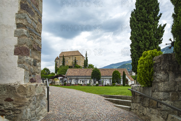 Picturesque cemetery with a view of Scena Castle, on the church hill of Scena above Merano, in the Burggrafenamt, South Tyrol, Italy, for editorial use only, Europe