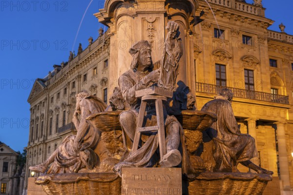 Statue of the sculptor and carver Tilman Riemenschneider at the Frankoniabrunnen in front of the Residenz at dusk, Würzburg, Bavaria, Germany, Europe