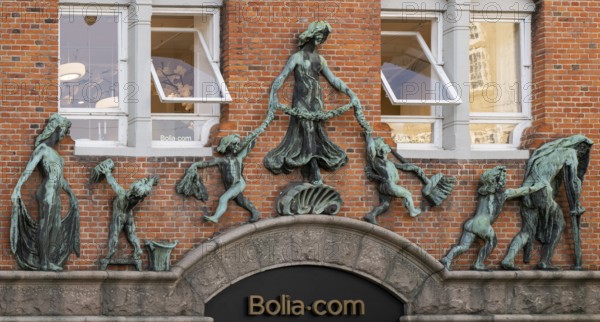 Red-brick building with bronze figures, theme of age, Christian IX Gade, Copenhagen, Denmark, Europe