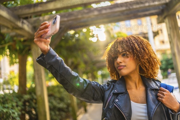 Latin beauty young woman taking selfie while enjoying a walk in the city