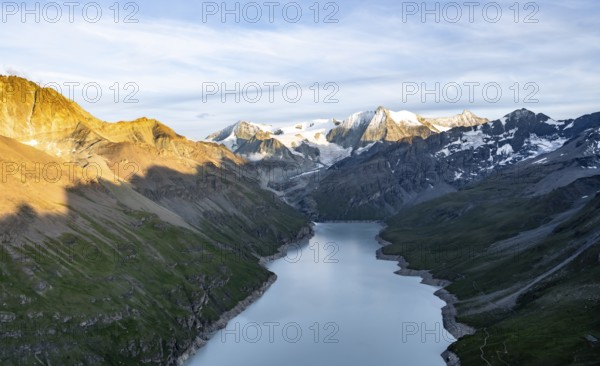 Picturesque mountain landscape at the summit Mont de la Blana at sunset, view of blue mountain lake, reservoir Lac des Dix and summit Mont Blanc de Cheilon with glacier, Hérémence, Valais, Western Alps, Switzerland, Europe