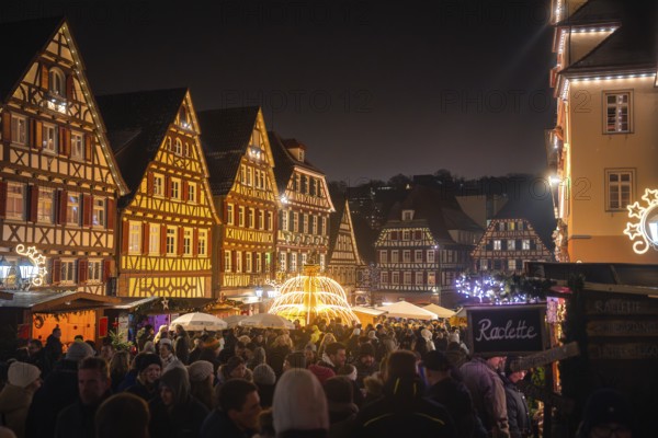 Lively Christmas market in a half-timbered town, illuminated by lamps and decorative lights, Christmas market Calw, Black Forest, Germany, Europe
