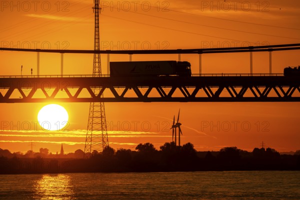 Traffic on the Rhine bridge Emmerich, federal road B220, evening light, with 803 m the longest suspension bridge in Germany shortly in front of the Dutch border, Rhine kilometre 853, 2 it is the northernmost German Rhine bridge, North Rhine-Westphalia, Germany, Europe