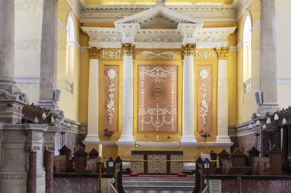 Elegant church interior with decorated altar and pillar details, Waterford