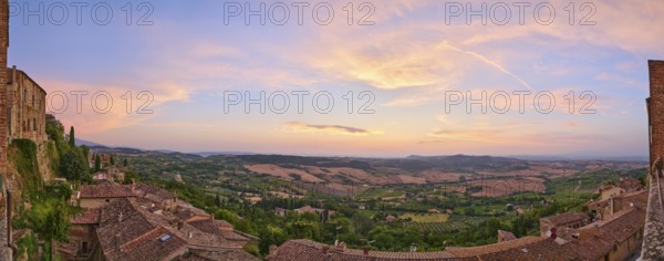 View from Montepulciano into a typical Tuscan landscape in Val d'Orcia with hills, trees, fields, cypresses and farm houses in summer, Montepulciano, Tuscany, Italy, Europe