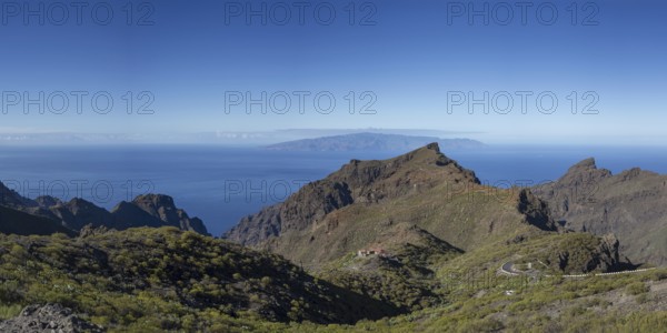 Volcanic rock formation and the Masca Gorge, Barranco de Masca, Teno Mountains, Tenerife, behind La Gomera, Canary Islands, Spain, Europe