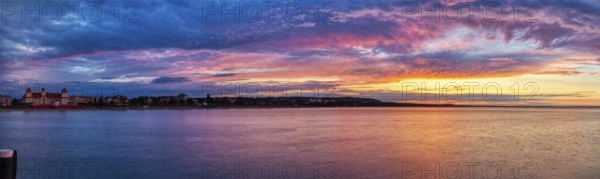 Panoramic view of a sea at sunset with dramatic sky in different colours, Rügen