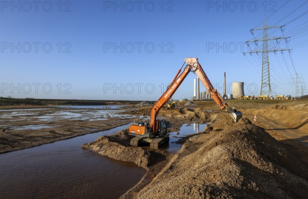 Dinslaken, North Rhine-Westphalia, Germany, New Emscher estuary into the Rhine. Construction site of the new Emscher estuary in front of the decommissioned STEAG coal-fired power station in Voerde. The mouth of the Emscher into the Rhine is being moved almost 500 metres north from Dinslaken to Voerde. Fish will then be able to swim barrier-free up the new Emscher from the Rhine through a newly created floodplain area. Following the construction of a parallel sewer, the Emscher has been completely free of sewage since January 2022. The river was previously an open, above-ground combined sewer with rainwater and wastewater, Europe
