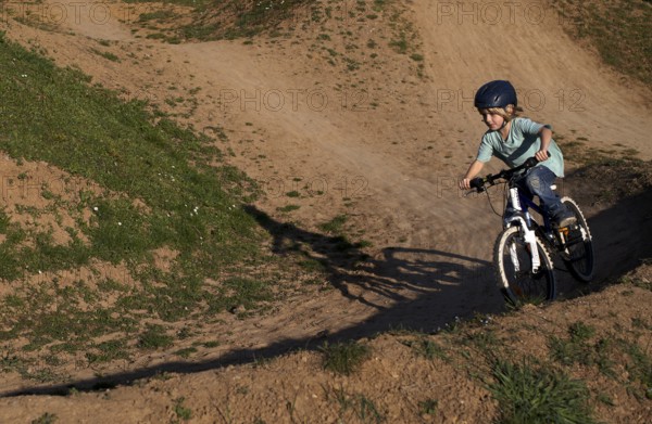 Little boy, 5 years, blond, rides with bicycle, crash helmet, cross, cross track, playground, Stuttgart, Baden-Württemberg, Germany, Europe
