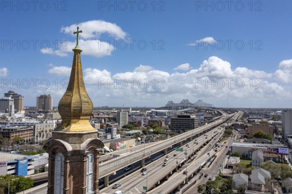 New Orleans, Louisiana - The golden steeple of St. John the Baptist Catholic Church, established in 1851. The church is next to Highway 90, near the bridge over the Mississippi River
