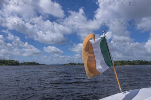 Irish flag waving on a boat, Ireland, Europe