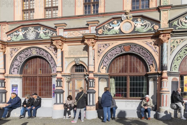 Ornate Renaissance portals on the Cranach House on Weimar's market square, with the town hall in the background, Thuringia, Germany, Europe