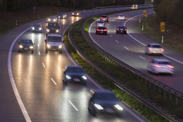 A night-time motorway scene with cars in motion and glowing lights on the road, Rems-Murr district, Baden-Württemberg, Germany, Europe