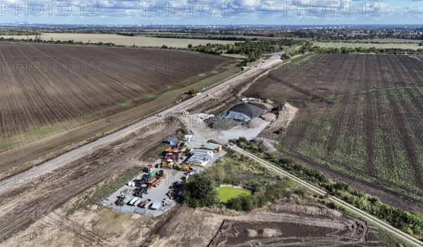 Construction vehicles are parked at an access road under construction to the High Tech Park at the site of the planned Intel chip factory. Intel stops the construction of its chip factory in Magdeburg until further notice, 29/09/2024, Magdeburg, Saxony-Anhalt, Germany, Europe