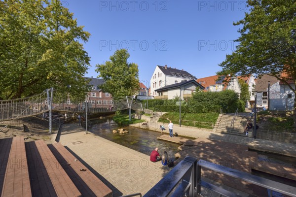 River Salze with suspension bridge for pedestrians and buildings at the Salzhof in Bad Salzuflen, Lippe district, North Rhine-Westphalia, Germany, Europe