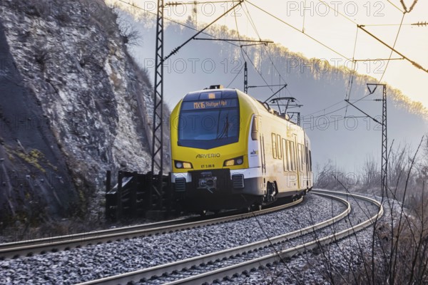 Geislinger Steige, railway line of the Filstallinie railway at dawn. Alb ascent to the Swabian Alb. Regional train operated by Arverio, travelling for the Baden-Württemberg mobility brand bwegt. Geislingen an der Steige, Baden-Württemberg, Germany, Europe