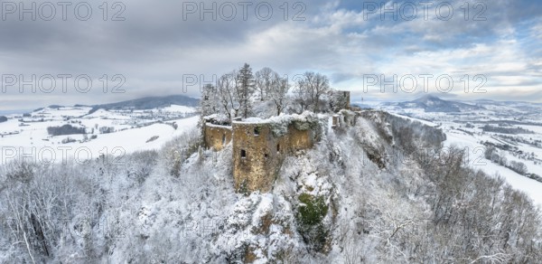 Aerial view, panorama of the snow-covered Hegau volcano Mägdeberg with remains of a castle wall on a cold winter morning, on the horizon on the left the neighbouring Hegau volcano Hohenstoffeln in the clouds, on the right the Hohenhewen, district of Constance, Baden-Württemberg, Germany, Europe