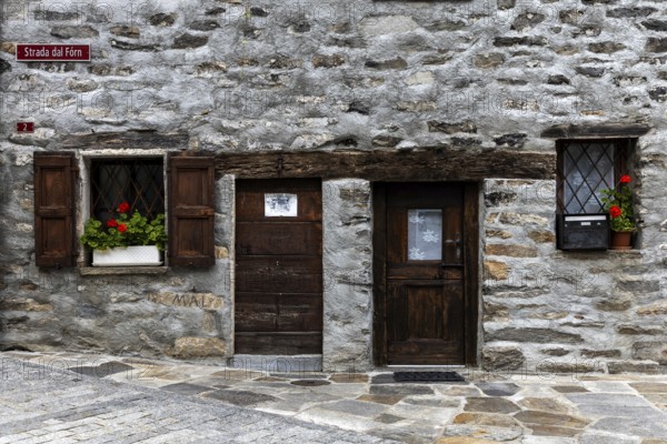 Entrance door and window of a typical Ticino stone house in the village of Sonogno, Verzasca Valley, Valle Verzasca, Canton Ticino, Switzerland, Europe