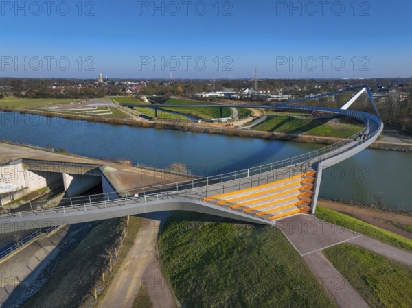 Castrop-Rauxel, North Rhine-Westphalia, Ruhr area, Germany - New construction of a bridge Sprung über die Emscher, a pedestrian and cycle bridge over the Emscher and the Rhine-Herne Canal. Construction project EMSCHERLAND, a 37-hectare water and nature adventure park at the water crossroads of the Rhine-Herne Canal and the renaturalised Emscher on the border between Recklinghausen and Castrop-Rauxel. EMSCHERLAND will also be a garden of the future for the International Garden Exhibition 2027. Before the renaturalisation, the Emscher river system was an open, above-ground wastewater channel, mixed water channel with surface water and wastewater