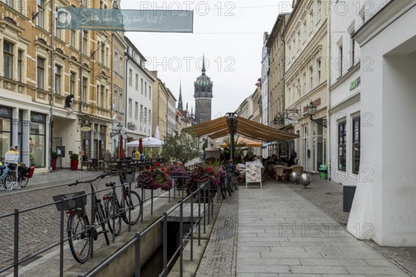 Röhrwasser, the historic water pipe system, in the shopping street, in the background the tower of the castle church, Luther city Wittenberg, Saxony-Anhalt, Germany, Europe