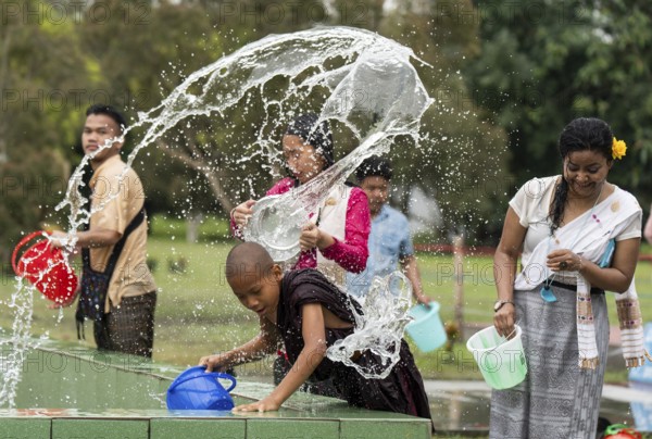 NAMSAI, INDIA.- APRIL 16: Devotees celebrate the vibrant Sangken Festival by pouring water over each other at Golden Pagoda in Namsai, India on 16 April 2025. Sangken Festival is a beautiful and culturally rich water festival celebrated primarily by the Theravada Buddhist communities, it marks the Buddhist New Year, typically falling in mid-April