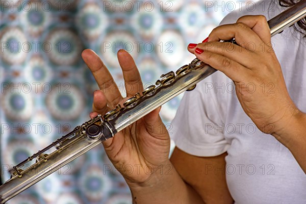 Detail of the hands of a woman playing the transverse flute during a musical performance Belo Horizonte, Minas Gerais, Brazil, South America