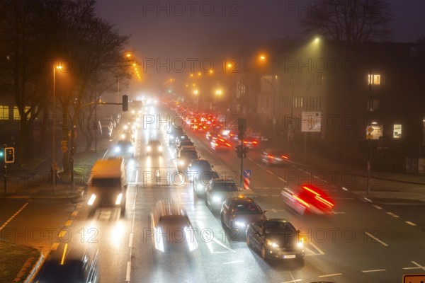 Dense fog, with visibility sometimes less than 100 metres, city centre traffic at rush hour on Alfredstraße, B224, in Essen, North Rhine-Westphalia, Germany, Europe