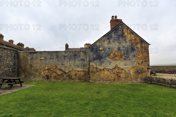 Façade with mural, St Michael's Mount, tidal island with castle, rain clouds, Marazion, Cornwall, England, Great Britain