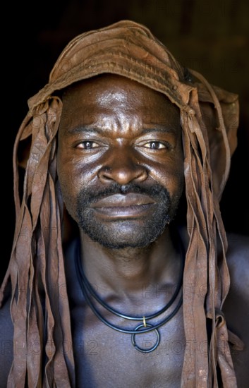 Himba man in his hut, Ohandungu, Kunene region, Kaokoveld, Namibia, Africa