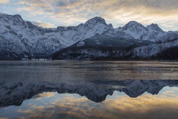 Lake Almsee in winter. Snow on the mountains and some clouds in the sky