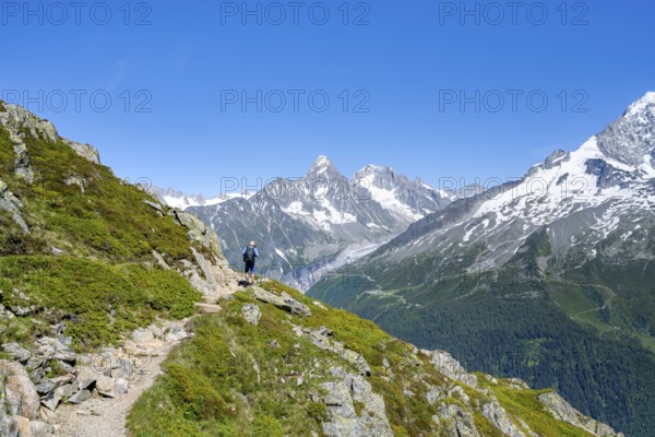 Mountaineer on a hiking trail in front of mountain landscape, view of mountain peak Aiguille du Tour of the Mont Blanc massif, Aiguilles Rouges, Chamonix-Mont-Blanc, Haute-Savoie, France, Europe