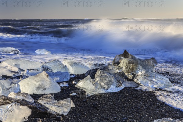 Ice floes on the beach, waves, sea, sunny, morning light, winter, Diamond Beach, Breidamerkursandur, Jökulsarlon, Iceland, Europe