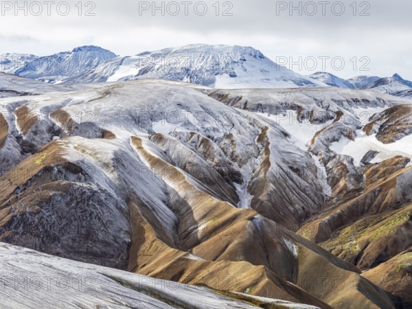 Early snow on the colorful rhyolite mountains, Landmannalaugar, Fjallabak Nature Reserve, Iceland, Europe