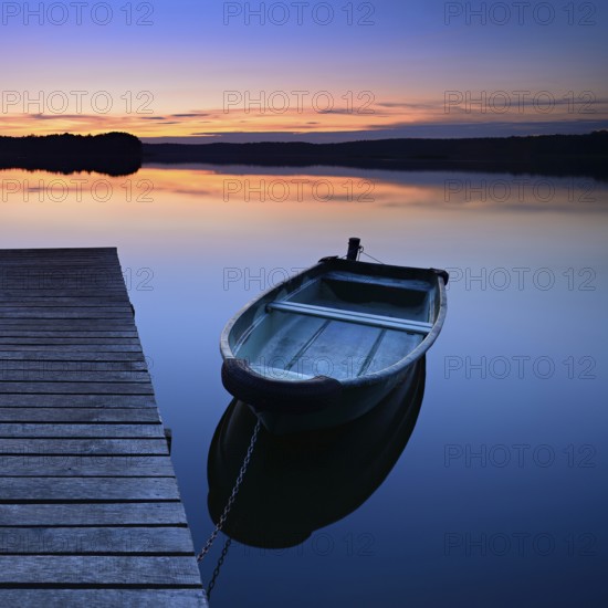 Quiet lake with jetty and rowing boat after sunset at dusk, Großer Lychensee, Lychen, Brandenburg, Germany, Europe