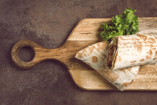 Cut shawarma, 2 pieces, on a cutting board, close-up
