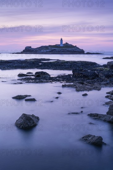 Godrevy Lighthouse, the lighthouse of Godrevy on Godrevy Island. In the evening at sunset. Long exposure. Cornwall, England, Great Britain