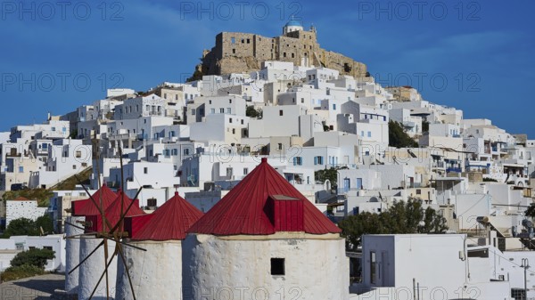 Castle and windmills above white houses under a sunny sky, Querini Castle, Chora, Astypalea, Dodecanese, Greek Islands, Greece, Europe
