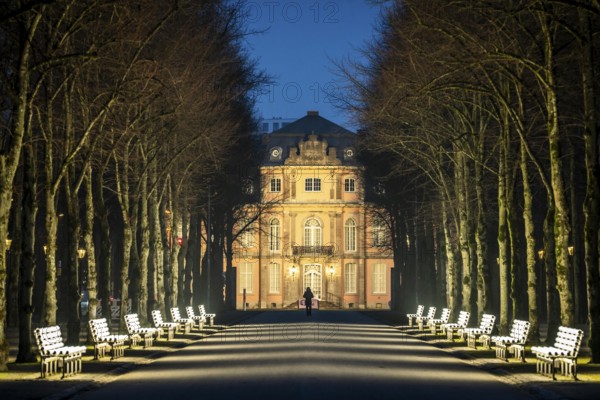 The light benches by artist Stefan Sous in the Hofgarten, entitled UV-A UV-B, 14 completely refurbished exhibits from the 2002 light-grey art exhibition, which now stand and light up as a permanent work of art on Jägerhofallee, LED technology, in the background Jägerhof Palace, home of the Goethe Museum, Düsseldorf, North Rhine-Westphalia, Germany, Europe