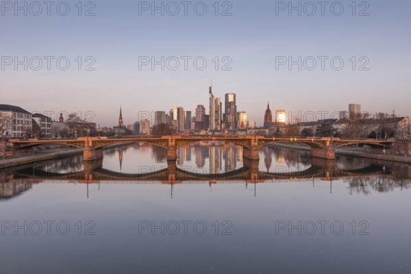 The Frankfurt bank skyline is reflected in the Main River in the morning, shortly after sunrise, Frankfurt am Main, Hesse, Germany, Europe