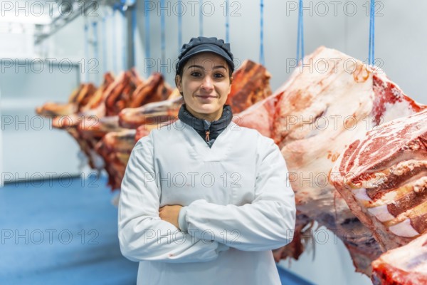 Portrait of a woman worker standing proud in the cold storage room of a meat factory