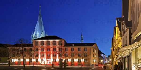 Illuminated town hall with St Patrokli Cathedral in the evening at the Winter Radiance Festival of Lights in Soest, North Rhine-Westphalia, Germany, Europe
