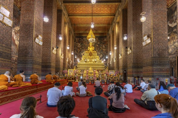 Prayer with monks in the Buddhist Phra Ubosoth, Wat Pho temple complex in Bangkok, Thailand, Asia