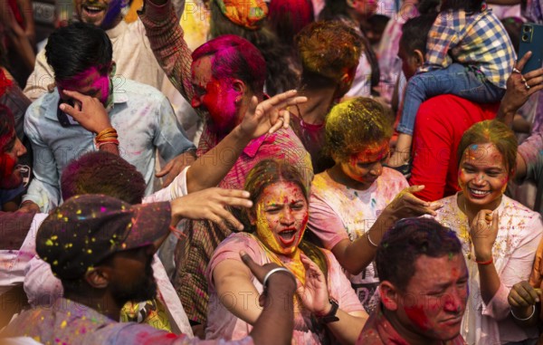 Revellers smear with Gulal or coloured powder and dance to play Holi, the Hindu spring festival of colours, on March 14, 2025 in Guwahati, India, Asia
