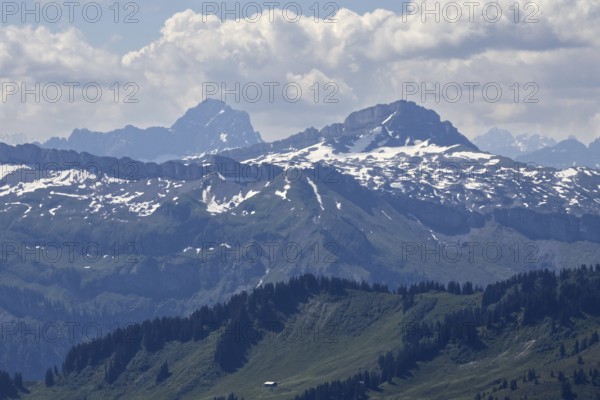View from Hochgrat of imposing snow-covered Alps with clouds and blue sky, Oberstaufen, Bavaria, Germany, Europe