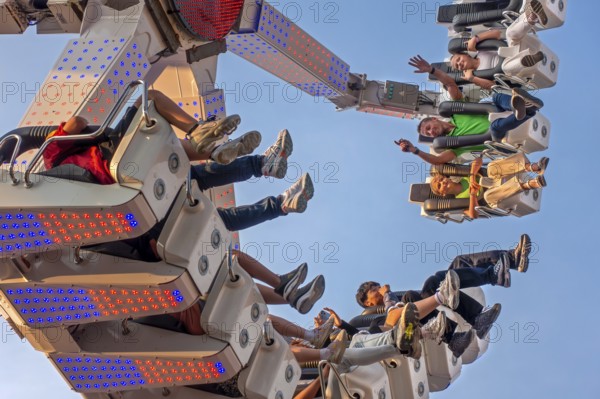 Thrillseekers having fun on fairground attraction during the Gentse Feesten, Ghent city festival, summer festivities at Ghent, East Flanders, Belgium, Europe