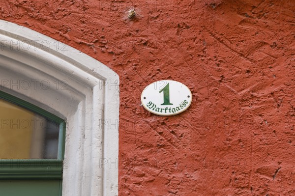 House number Marktgasse 1 on a red façade on the market square in Meißen, Saxony, Germany, Europe
