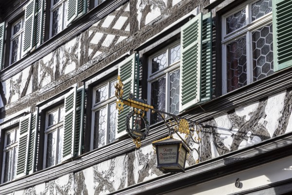 Façade with half-timbering and shutters and historic nose sign, famous Schlenkerla brewery, Bamberg, Bavaria, Germany, Europe