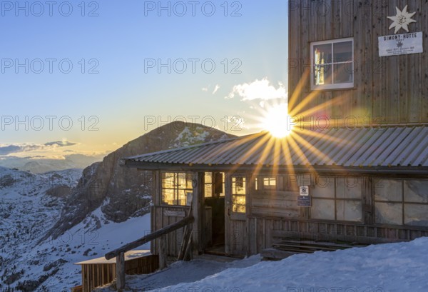 Sun shining through the windows of a snow-covered mountain hut, Simonyhütte, Upper Austria, Austria, Europe